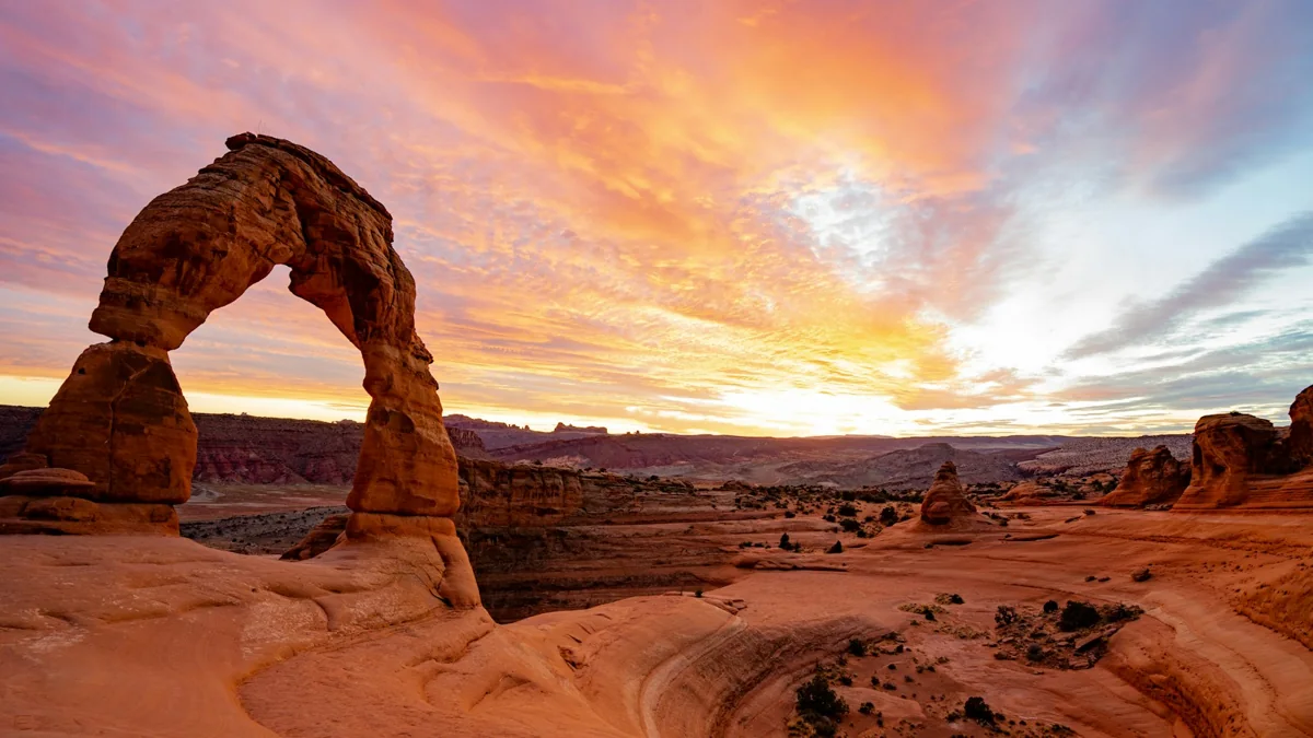 Delicate Arch beneath a colorful sunset near Moab, Utah.